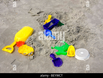 Beach toys appear to be abandoned in the sand. Stock Photo