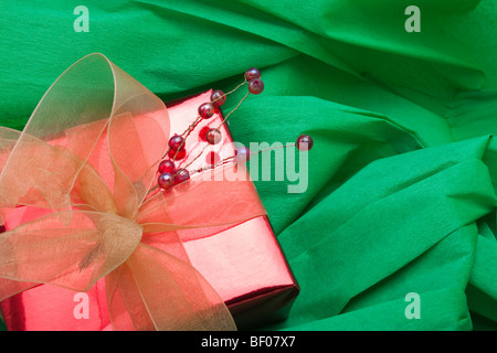 Christmas parcel decoration on green crepe paper background Stock Photo