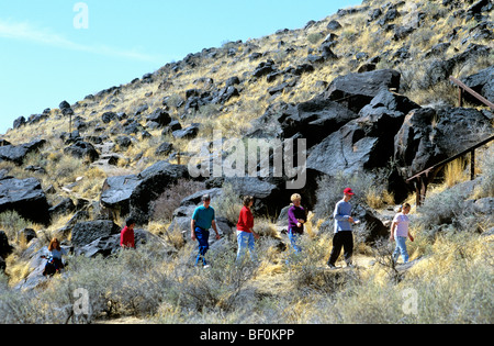 Visitors explore Petroglyph National Monument Albuquerque's West Mesa New Mexico USA. Stock Photo