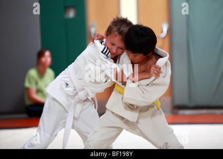 A judo class for kids and children with adults supervising the training Stock Photo