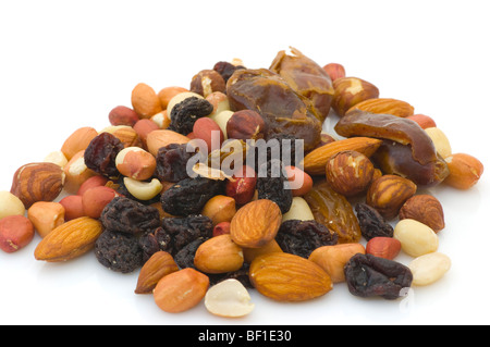 Pile Of Mixed Nuts and Dried Fruit Against A White Background Stock Photo