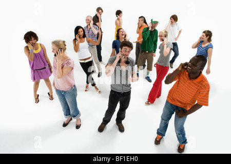 Group of men and women using mobile phones Stock Photo