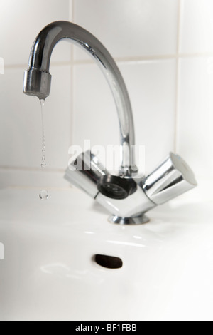 Water dripping from a bathroom faucet Stock Photo