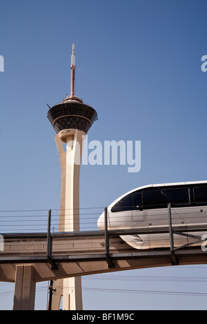 Looking up at the Las Vegas monorail train on its elevated route, passing the tower of the Stratosphere Hotel. Stock Photo