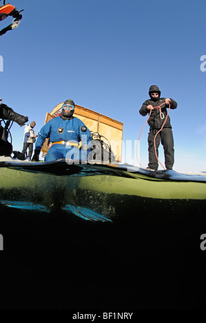 ice diving, split shot from ice divers and safty rope, White Sea, Russia Stock Photo