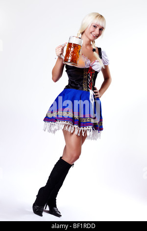 Young woman in folk costume holding a glass of beer Stock Photo