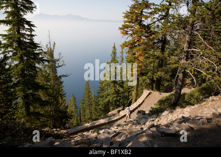 Cleetwood Cove Trail - Crater Lake National Park Oregon. Man hiking towards cove. Stock Photo