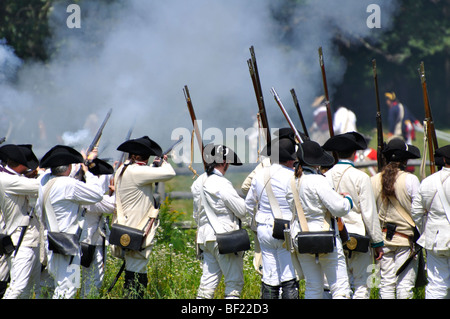 Battle between British Redcoats and American Patriots - costumed American Revolutionary War (1770's) era re-enactment Stock Photo