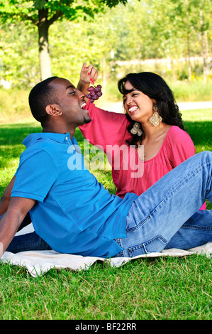Young romantic couple having picnic in summer park Stock Photo