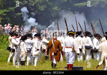Battle between British Redcoats and American Patriots - costumed American Revolutionary War (1770's) era re-enactment Stock Photo