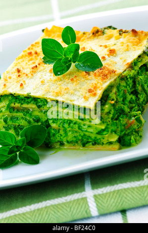 Serving of fresh baked vegeterian spinach lasagna on a plate Stock Photo