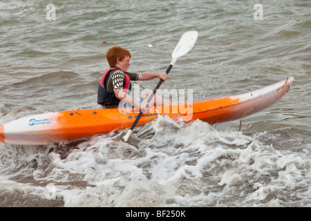 A kayaker riding out through the surf in Teos, Western Turkey Stock Photo