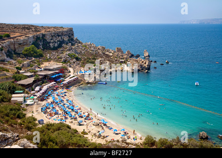 People at the beach in a little bay, Paradise Bay, Malta, Europe Stock Photo