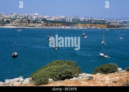 The mouth of Portimão harbour in southern Portugal's Algarve province. Across the bay is Portimão marina and Praia da Rocha Stock Photo