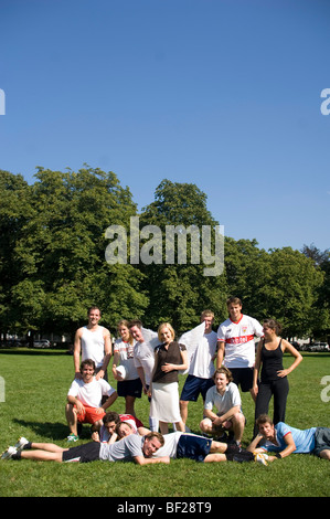 Angel, young woman with wings in a team photo, football in the park, Munich, Bavaria, Germany Stock Photo