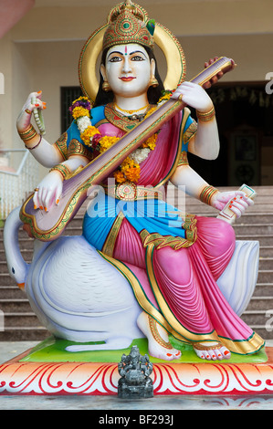 Indian Saraswati hindu goddess statue, outside music college in Puttaparthi, Andhra Pradesh, India Stock Photo