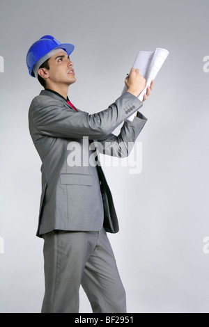 Architect engineer with blue hardhat and suit isolated on gray Stock Photo