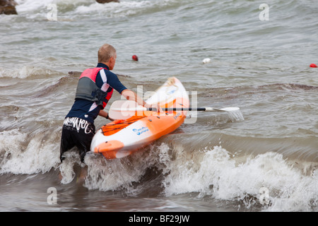 A kayaker riding out through the surf in Teos, Western Turkey Stock Photo