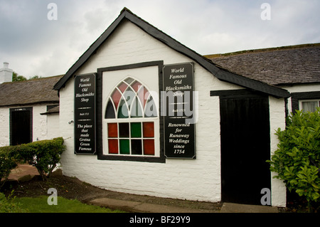 Arched window with coloured glass. Exterior façade of the Old Blacksmith's shop - wedding venue at Gretna Green, Scotland, UK Stock Photo