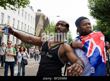 Two young men posing with uk flag at Notting Hill Carnival Stock Photo