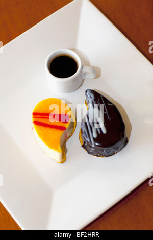 High angle view of assorted pastries and a cup of black coffee Stock Photo