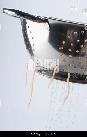 Boiled spaghetti in a strainer Stock Photo