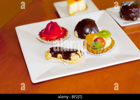 High angle view of assorted tarts and eclairs Stock Photo