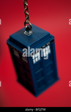 A Doctor Who Tardis keyring hangs in front of a background. Stock Photo