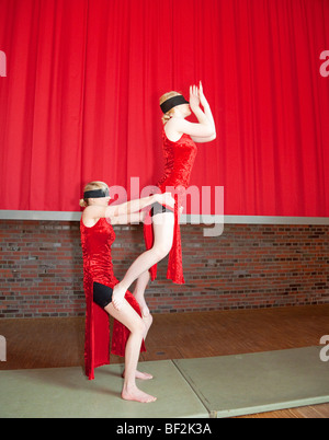 Two Girls showing acrobatic Act -Circus Performance Stock Photo