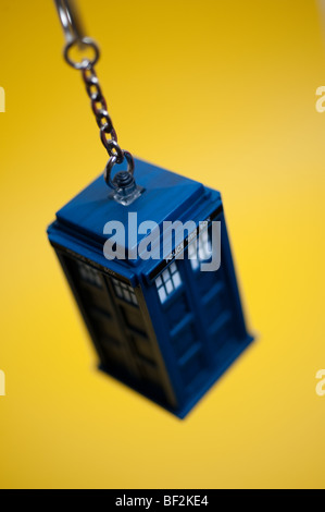 A Doctor Who Tardis keyring hangs in front of a background. Stock Photo
