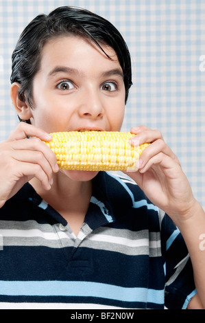 Boy eating corn on the cob Stock Photo