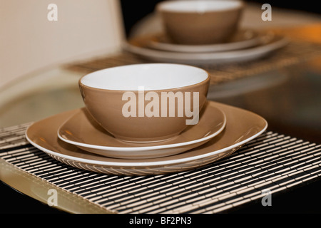 Bowls and plates on a dining table Stock Photo