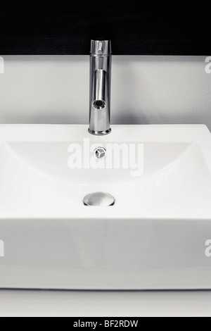 Faucet on a wash bowl in the bathroom Stock Photo
