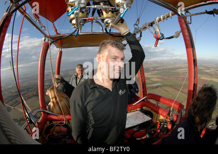Hot air balloon pilot flies hot air balloon over Perthshire. Stock Photo