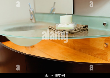 Candle with a towel on a wash bowl Stock Photo