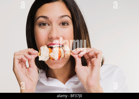 Portrait of a woman eating a shish kebab Stock Photo