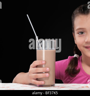 Close-up of a girl holding a glass of chocolate milkshake Stock Photo