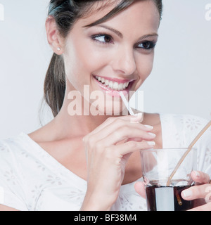 Close-up of a woman drinking a cola beverage Stock Photo