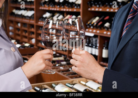 Couple toasting with wine glasses in a bar Stock Photo