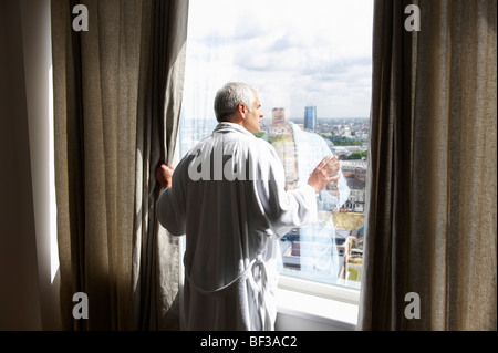 Man looking through the window Stock Photo