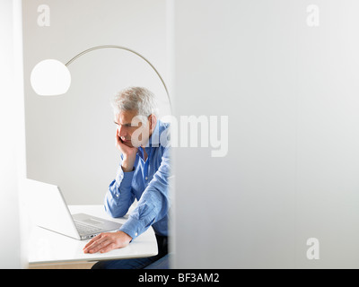 Man working on his computer Stock Photo