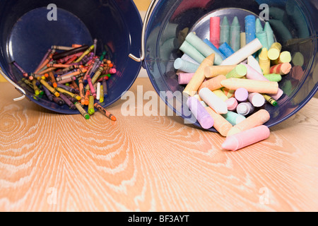 Crayons spilling out from containers Stock Photo