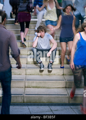 Portrait of lone young man in crowd