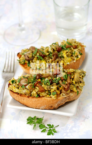 Scrambled eggs and mushrooms on toast Recipe available. Stock Photo