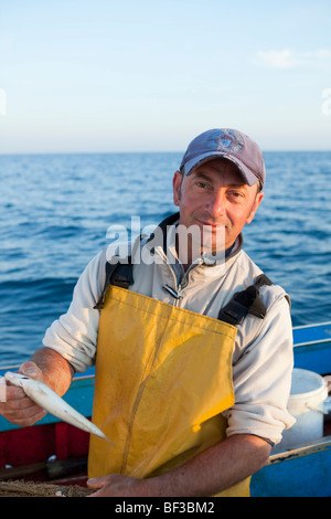 fisherman on his boat, laughing Stock Photo