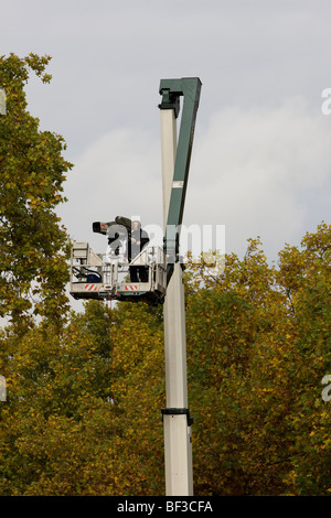 A television outside broadcast cameraman working from the top of a crane lift in London Stock Photo
