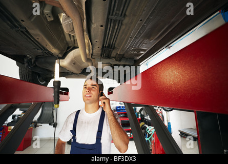 mechanic talking on mobile phone Stock Photo