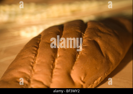 Close-up of a loaf of bread with ears of wheat Stock Photo