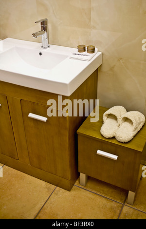 Slipper on a cabinet near a washbasin Stock Photo