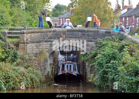 Narrowboat exiting lock 14 on the Marple lock flight, Cheshire Stock Photo